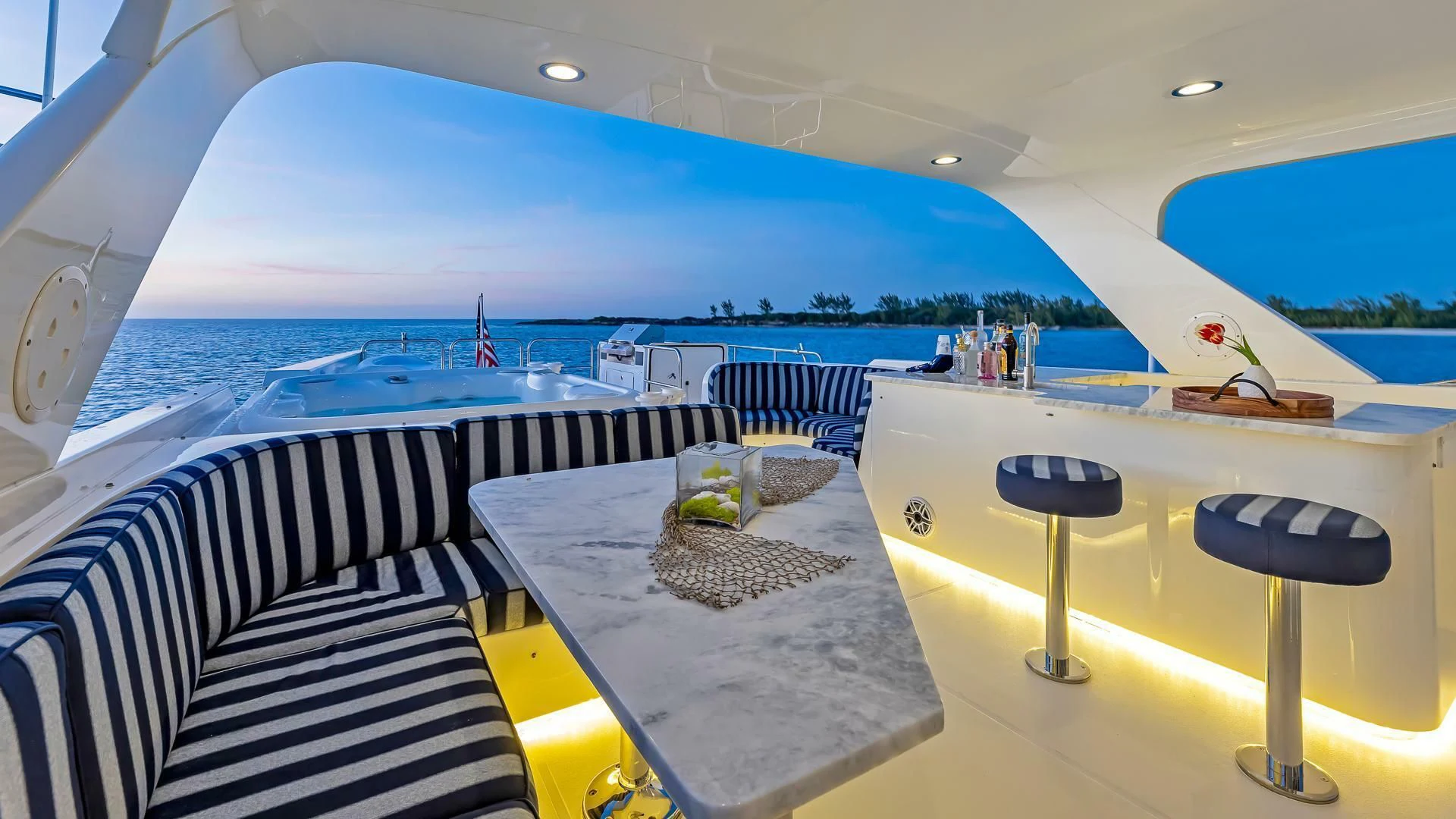 a large white boat with a table and chairs on the deck aboard LADY B Yacht for Sale