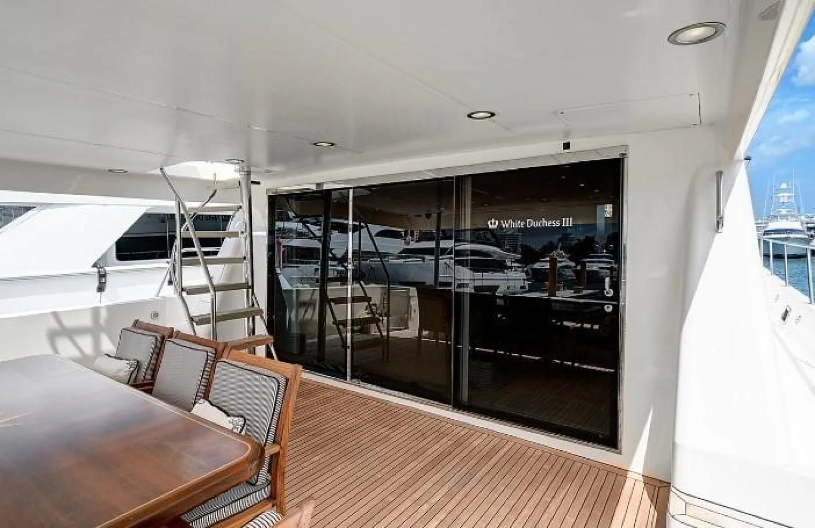 a room with a table chairs and a large window aboard LADY B Yacht for Sale