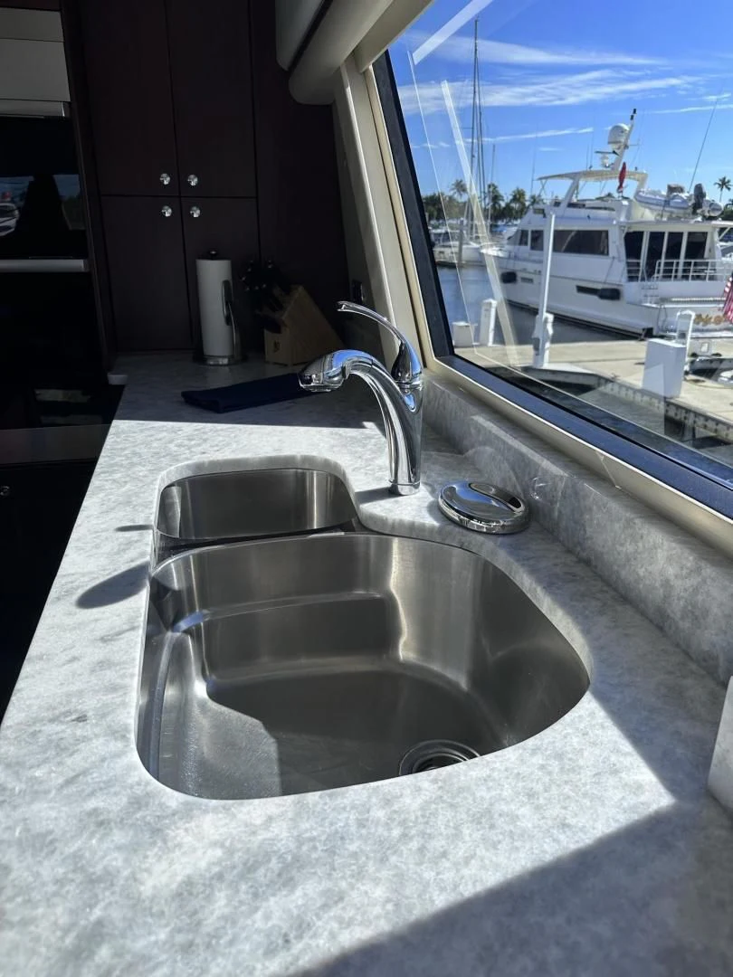 a bathroom sink with a large mirror aboard LADY B Yacht for Sale