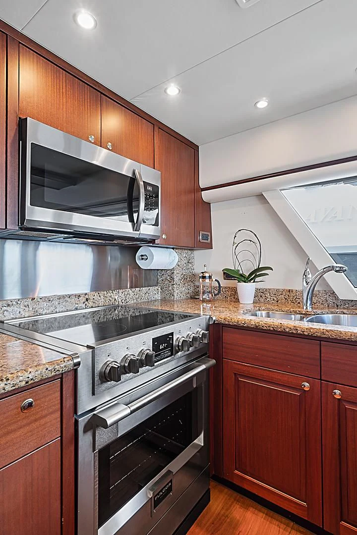 a kitchen with a stove and microwave aboard LADY B Yacht for Sale