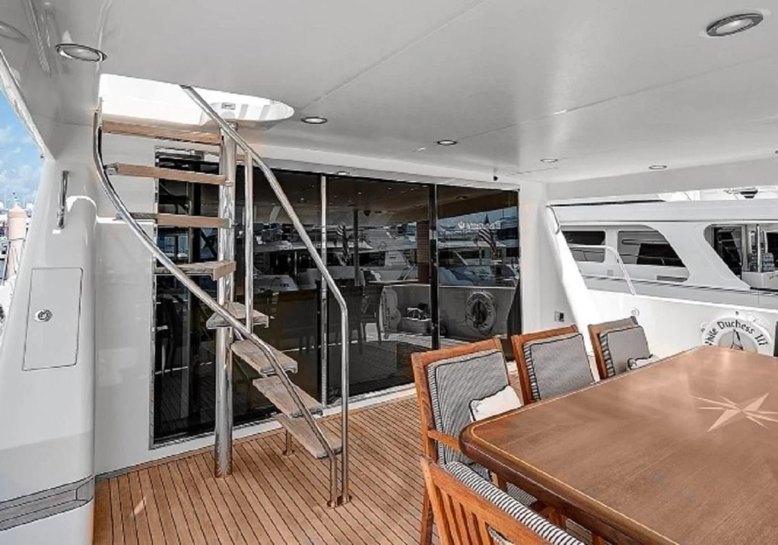 a room with a table and chairs aboard LADY B Yacht for Sale