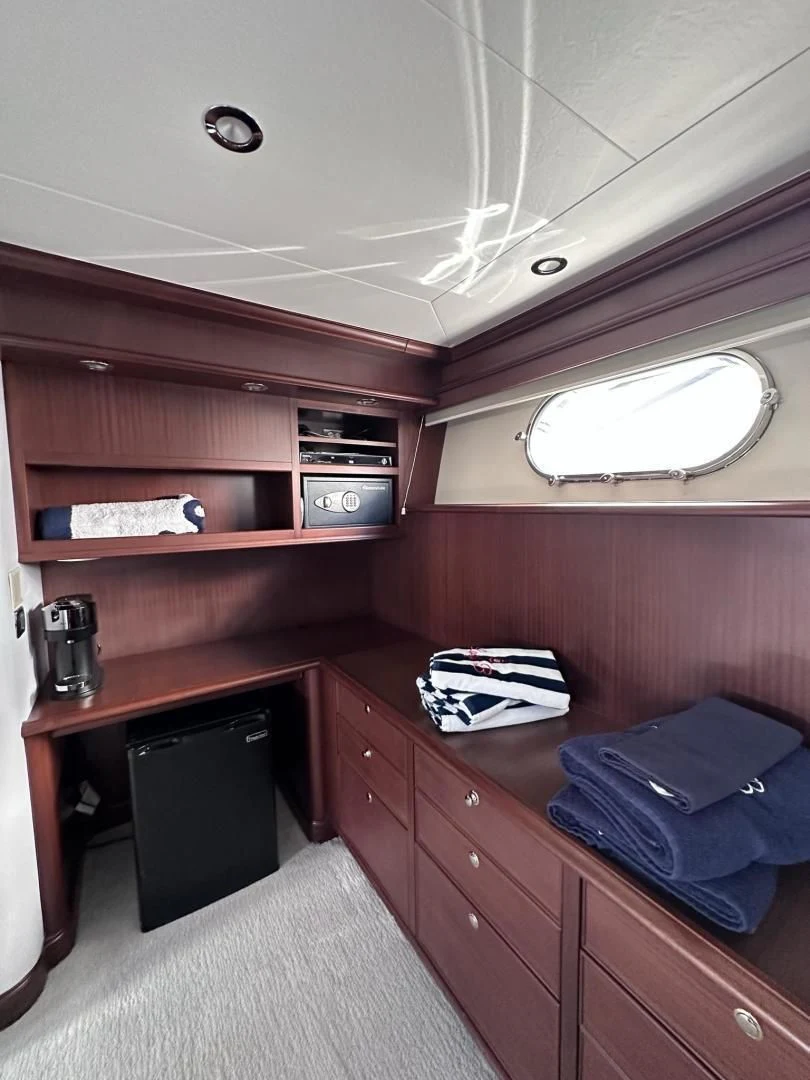 a room with a bed and a shelf with a microwave aboard LADY B Yacht for Sale