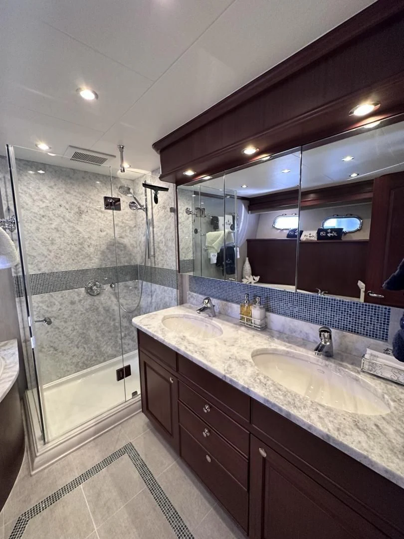 a bathroom with a large mirror aboard LADY B Yacht for Sale