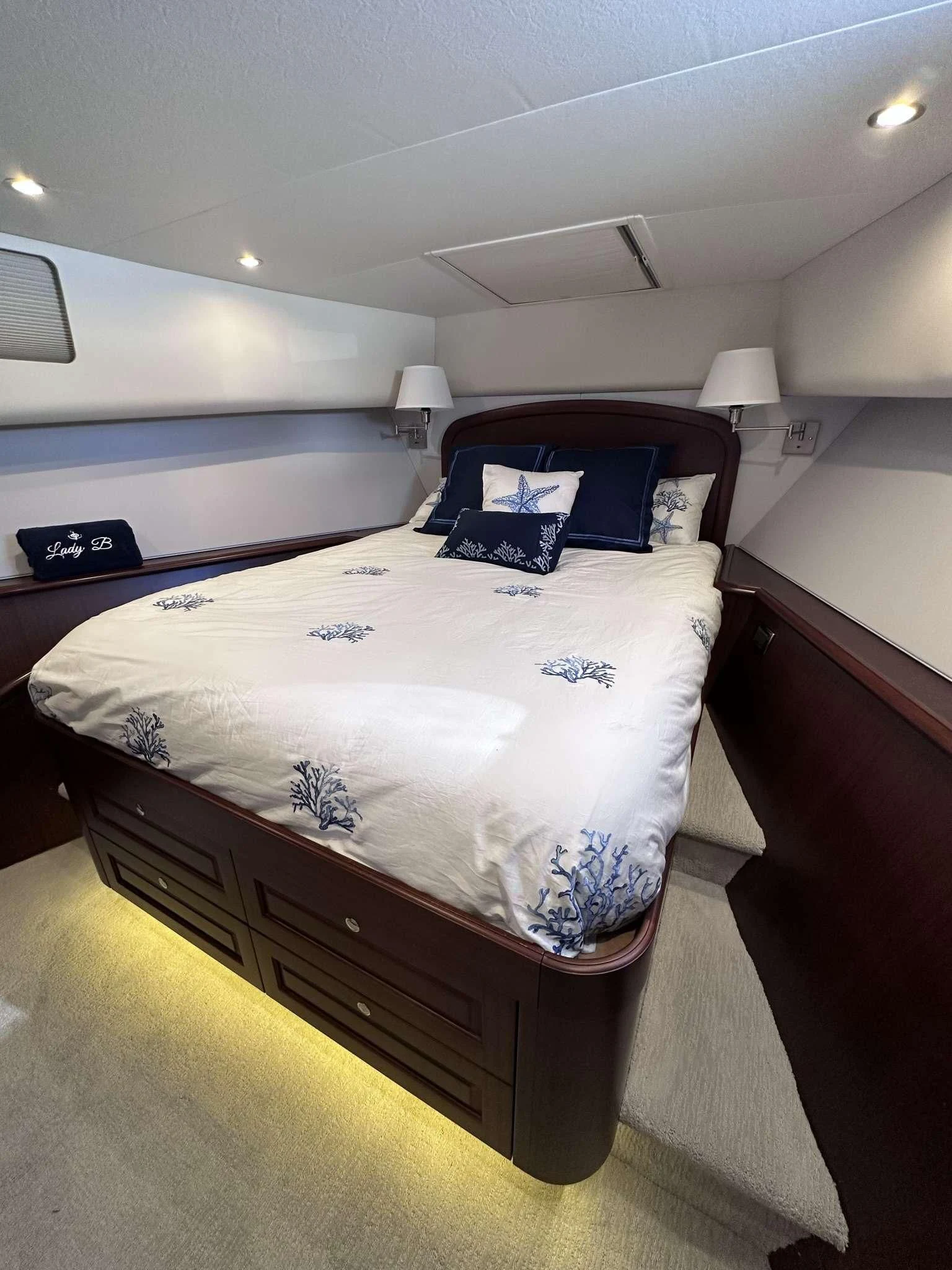 a bedroom with a bed and a desk aboard LADY B Yacht for Sale