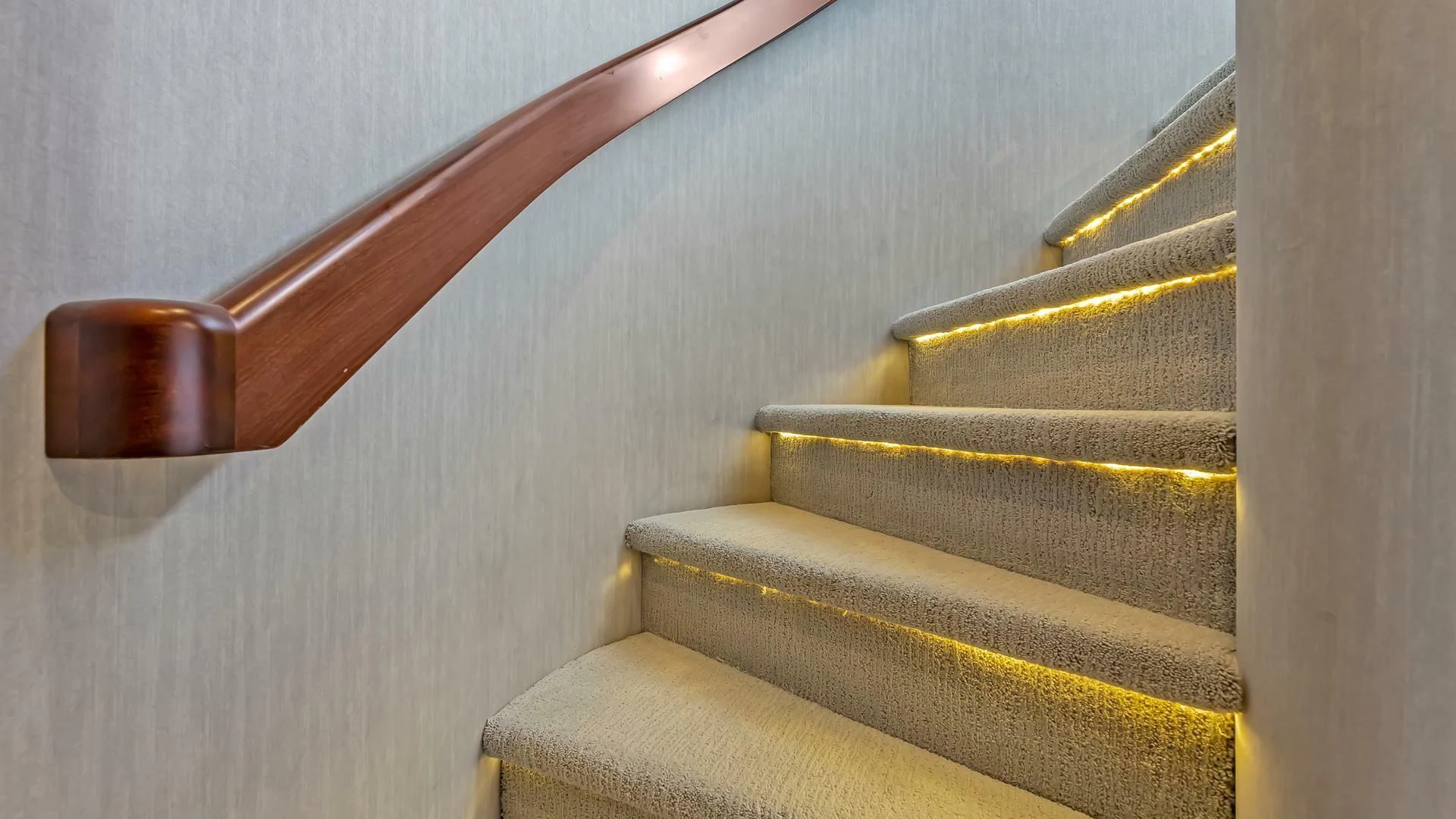 a wooden staircase with a metal railing aboard LADY B Yacht for Sale