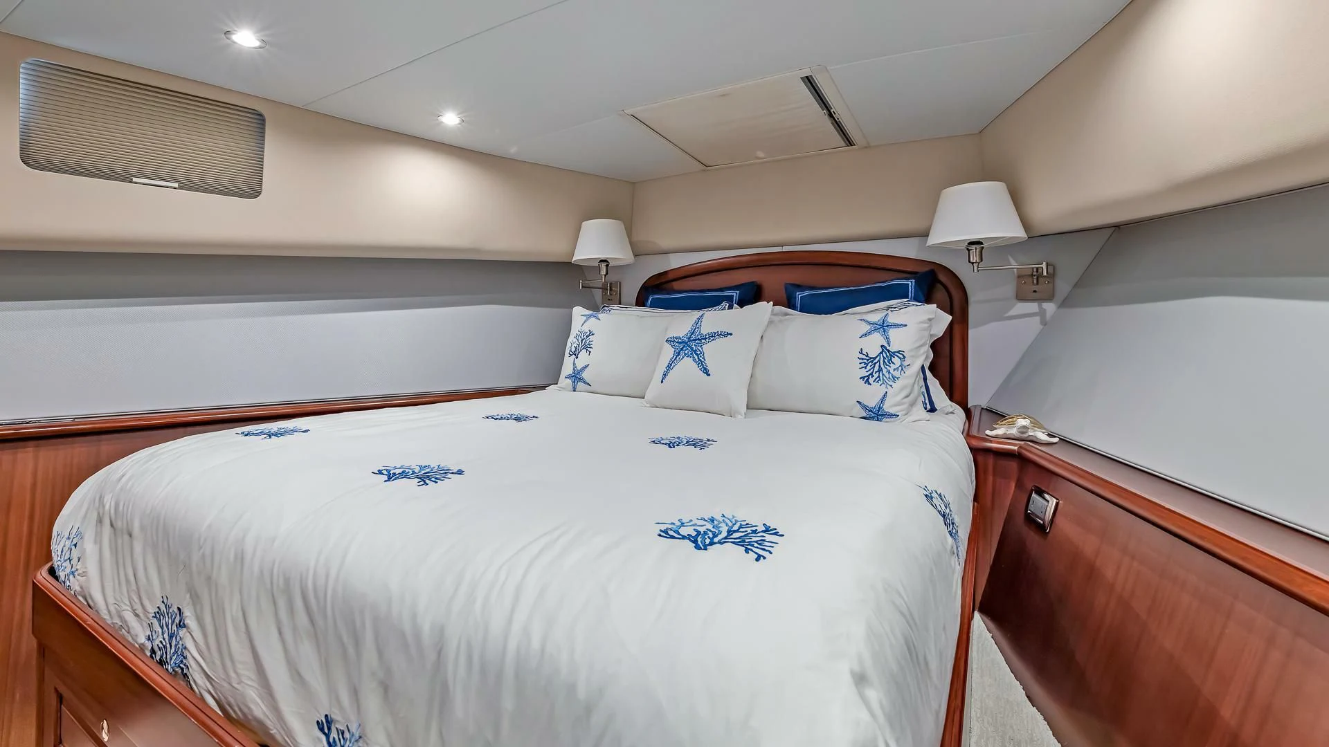 a bedroom with a bed and a lamp aboard LADY B Yacht for Sale