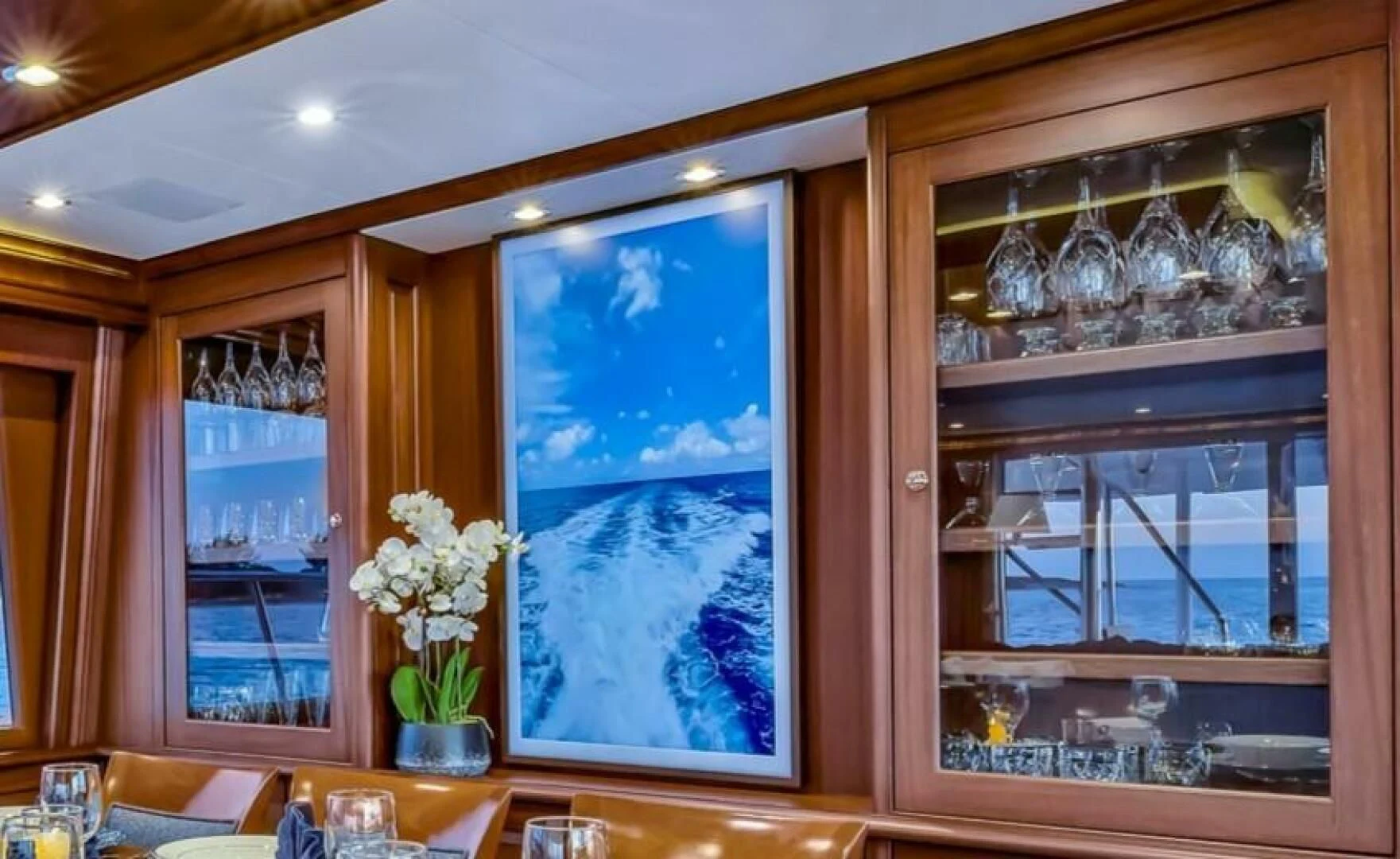 a room with a glass window and a vase with flowers in it aboard LADY B Yacht for Sale