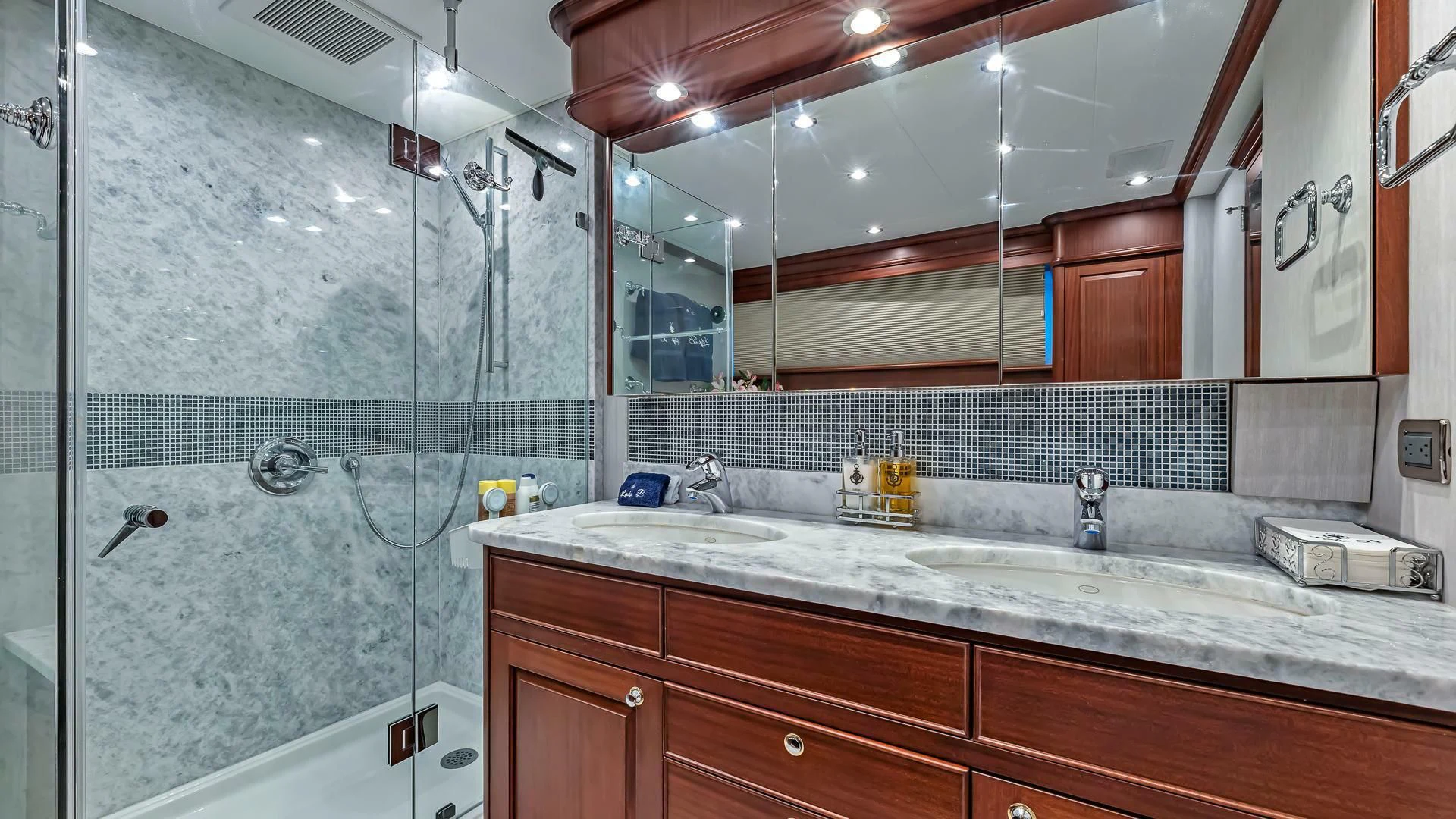 a bathroom with a large mirror aboard LADY B Yacht for Sale