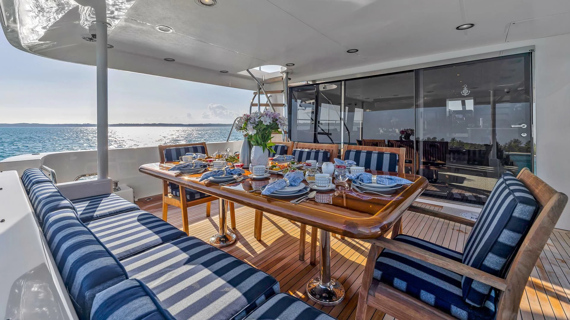 a dining room with a large window overlooking the ocean aboard LADY B Yacht for Sale
