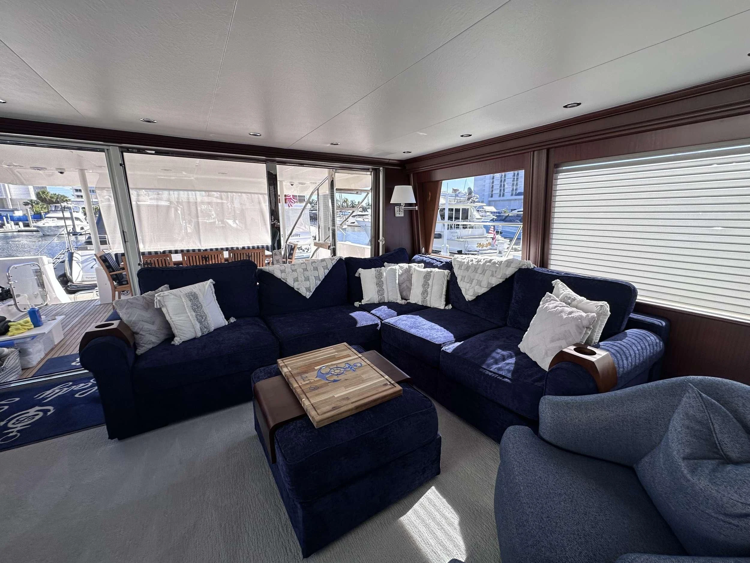 a living room with a large window aboard LADY B Yacht for Sale