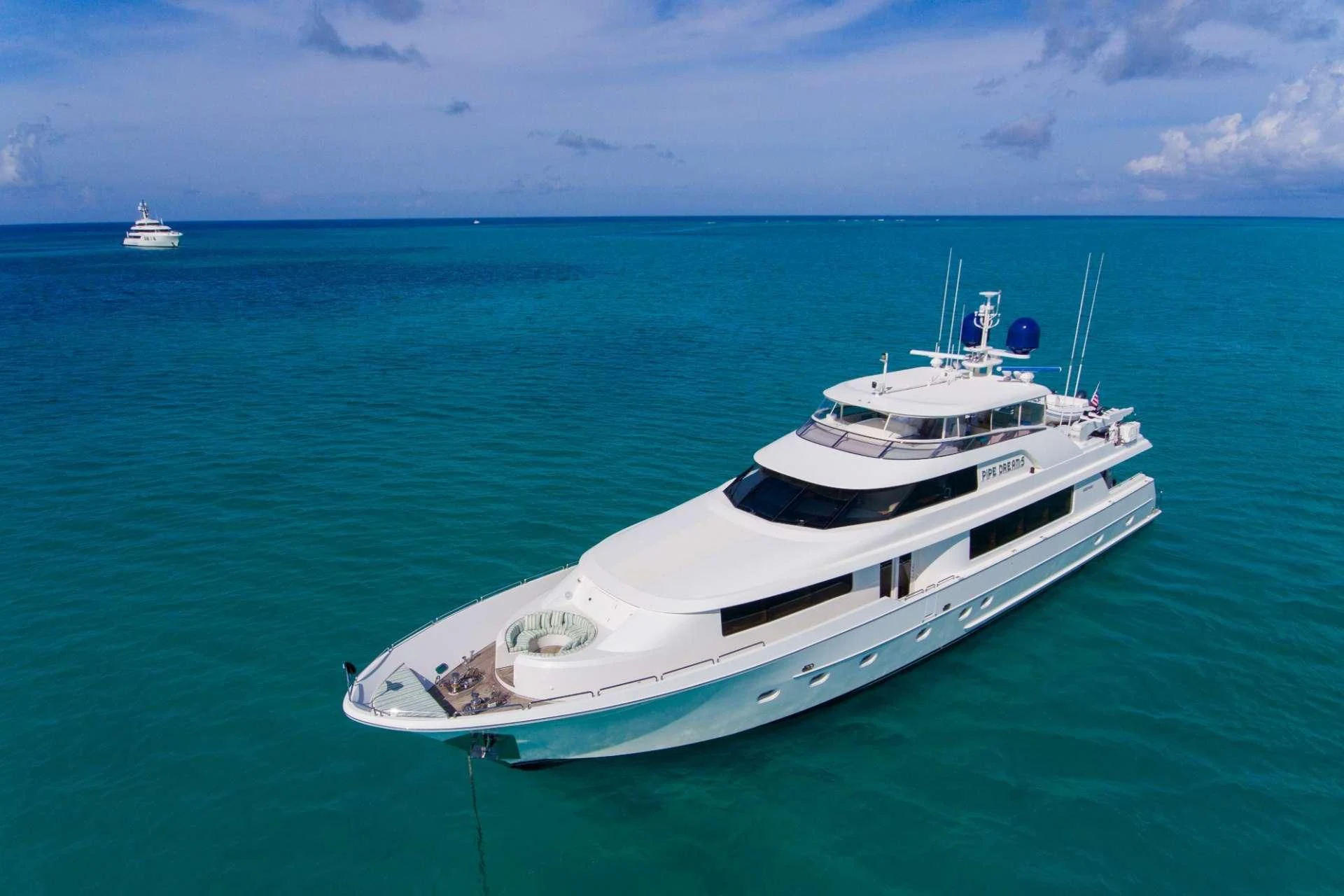 a white boat in the water aboard PIPE DREAMS Yacht for Sale
