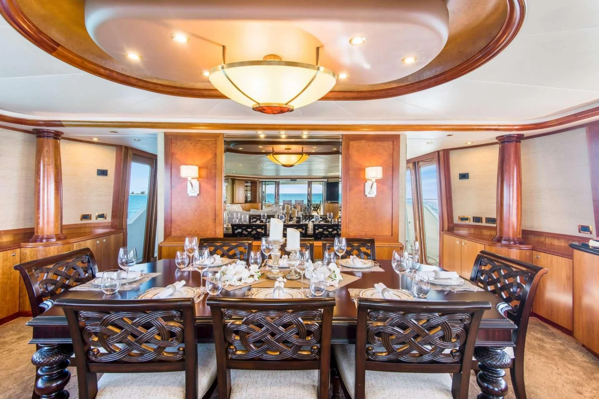 a large dining room with a chandelier aboard PIPE DREAMS Yacht for Sale