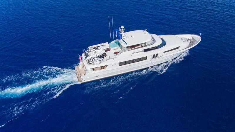 a white ship in the water aboard PIPE DREAMS Yacht for Sale