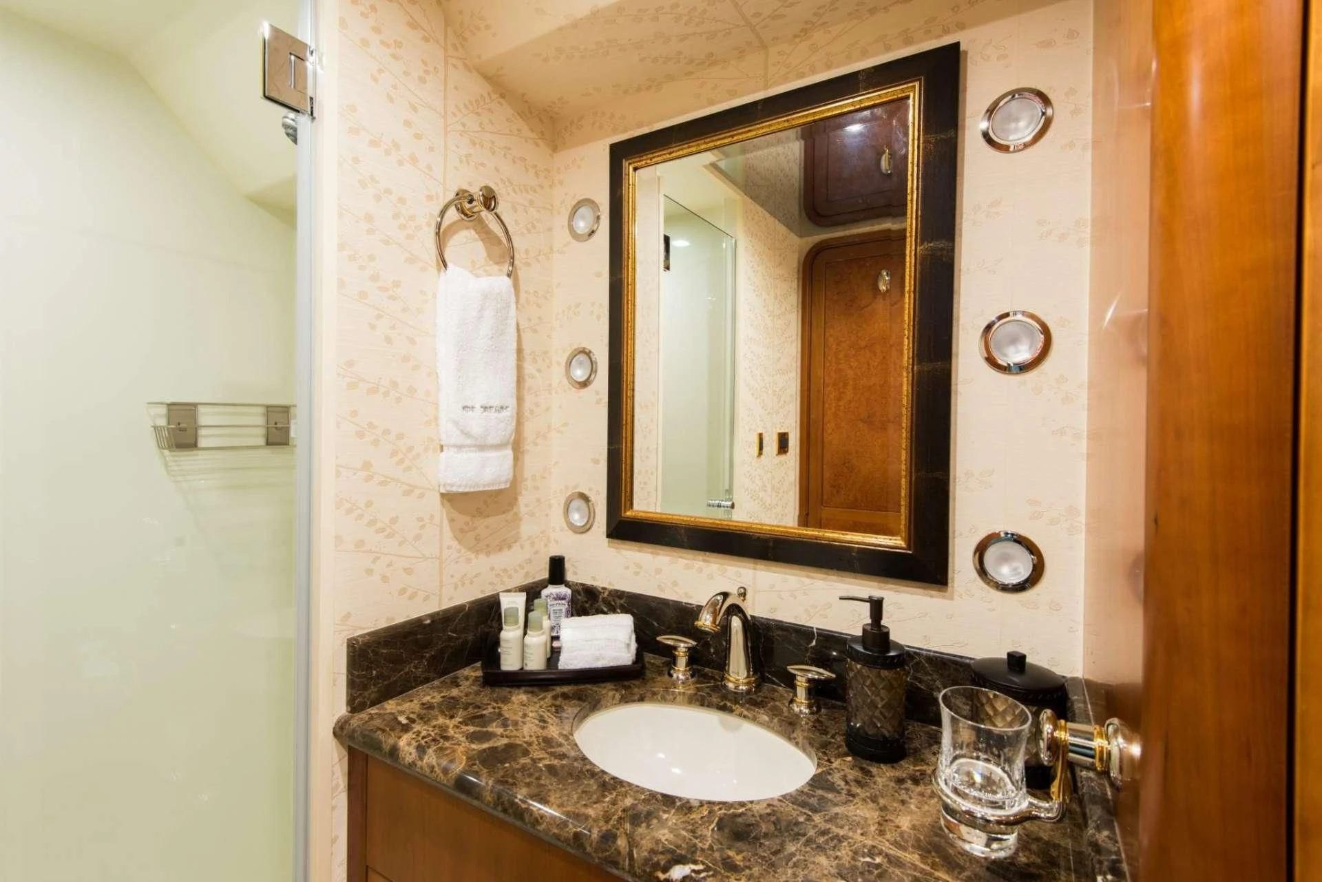 a bathroom with a mirror and a sink aboard PIPE DREAMS Yacht for Sale