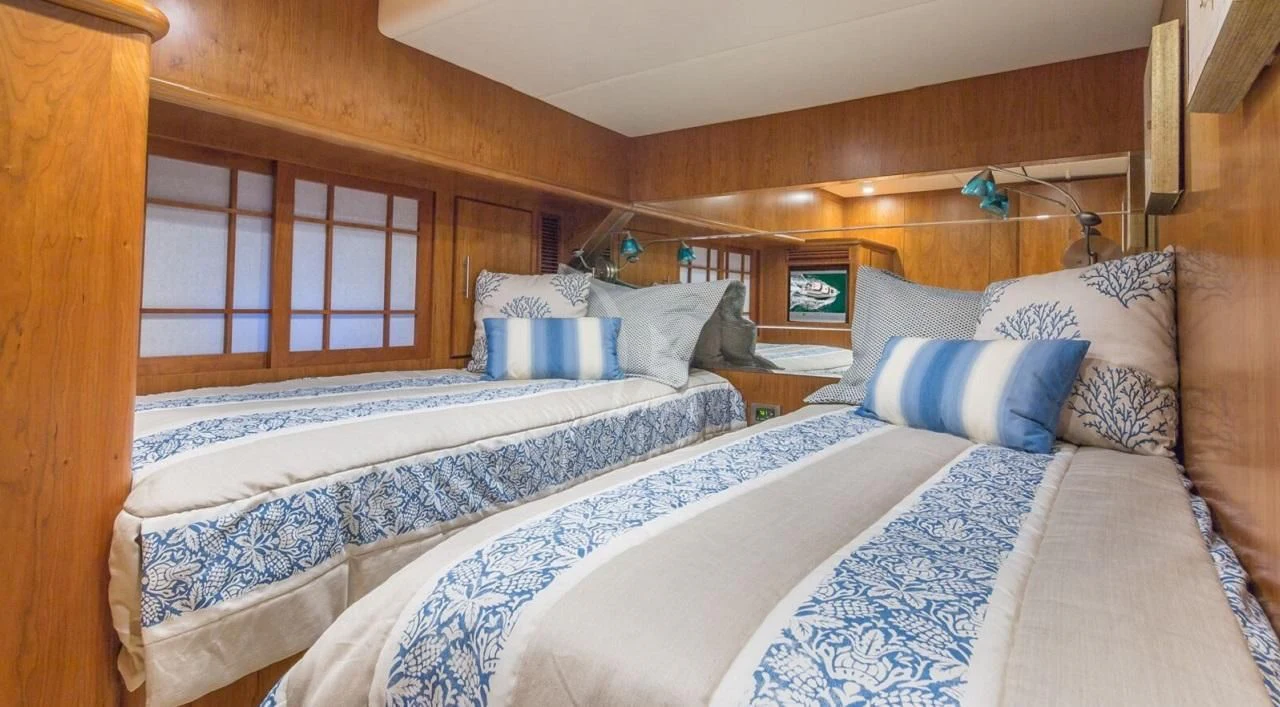 a couple of beds in a room aboard ANDIAMO Yacht for Charter