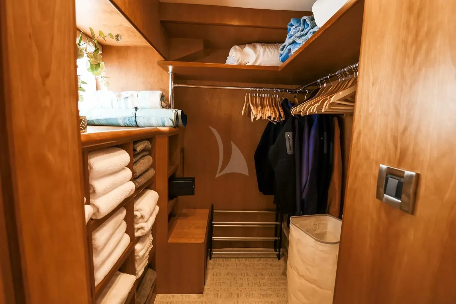 a closet with clothes on the wall aboard ANDIAMO Yacht for Charter