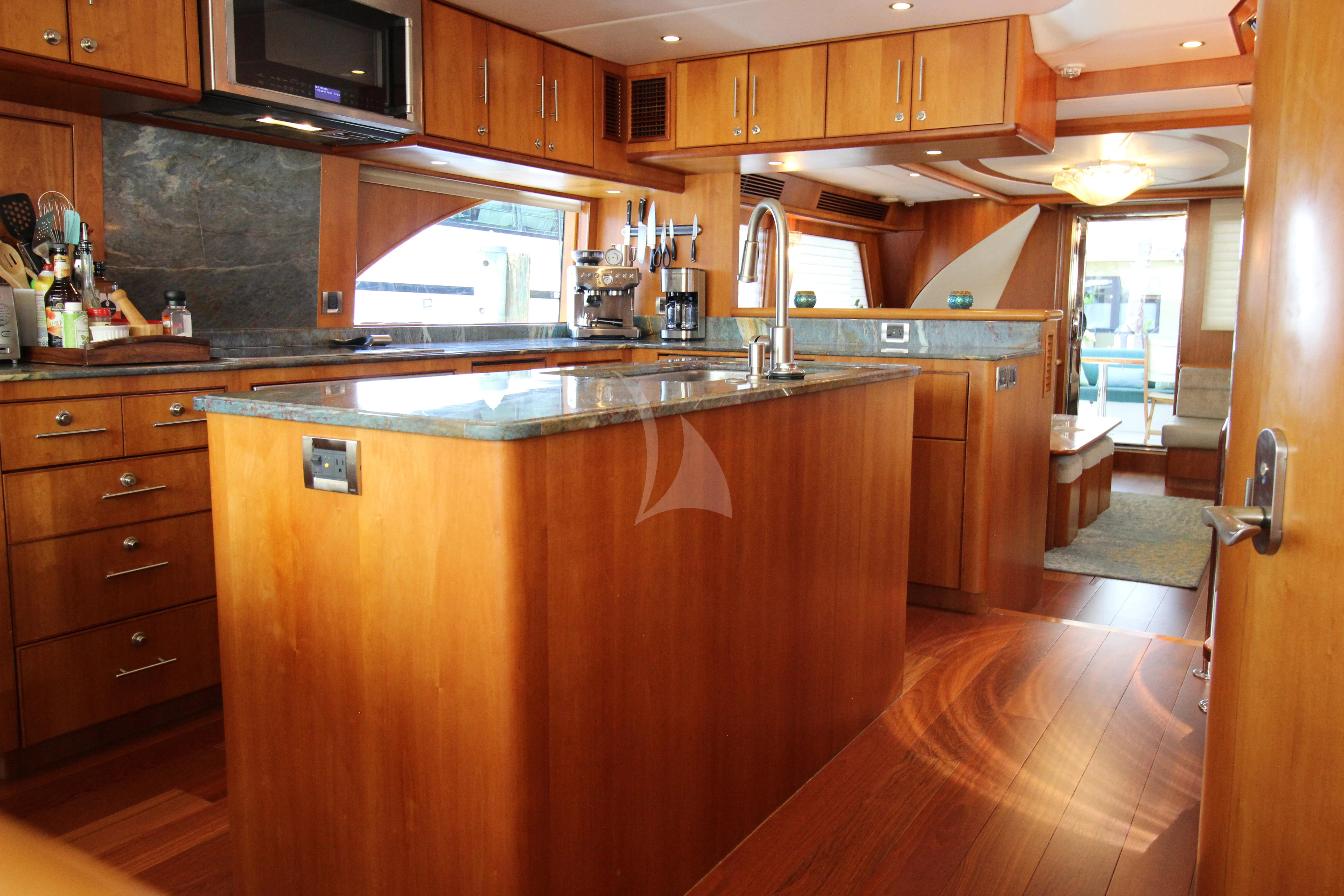 a kitchen with wooden cabinets aboard ANDIAMO Yacht for Charter