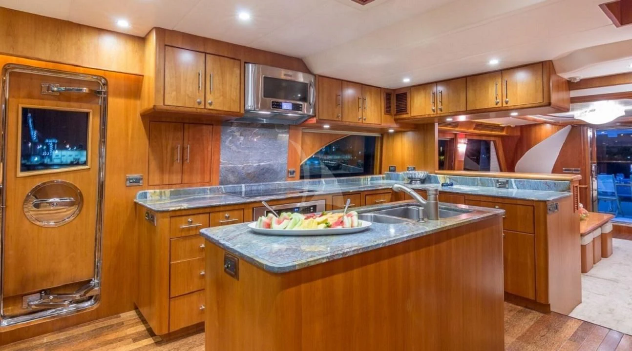 a kitchen with wooden cabinets aboard ANDIAMO Yacht for Charter