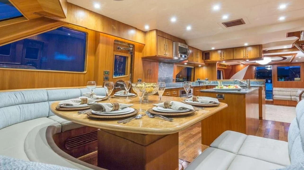 a large kitchen with a table set aboard ANDIAMO Yacht for Charter