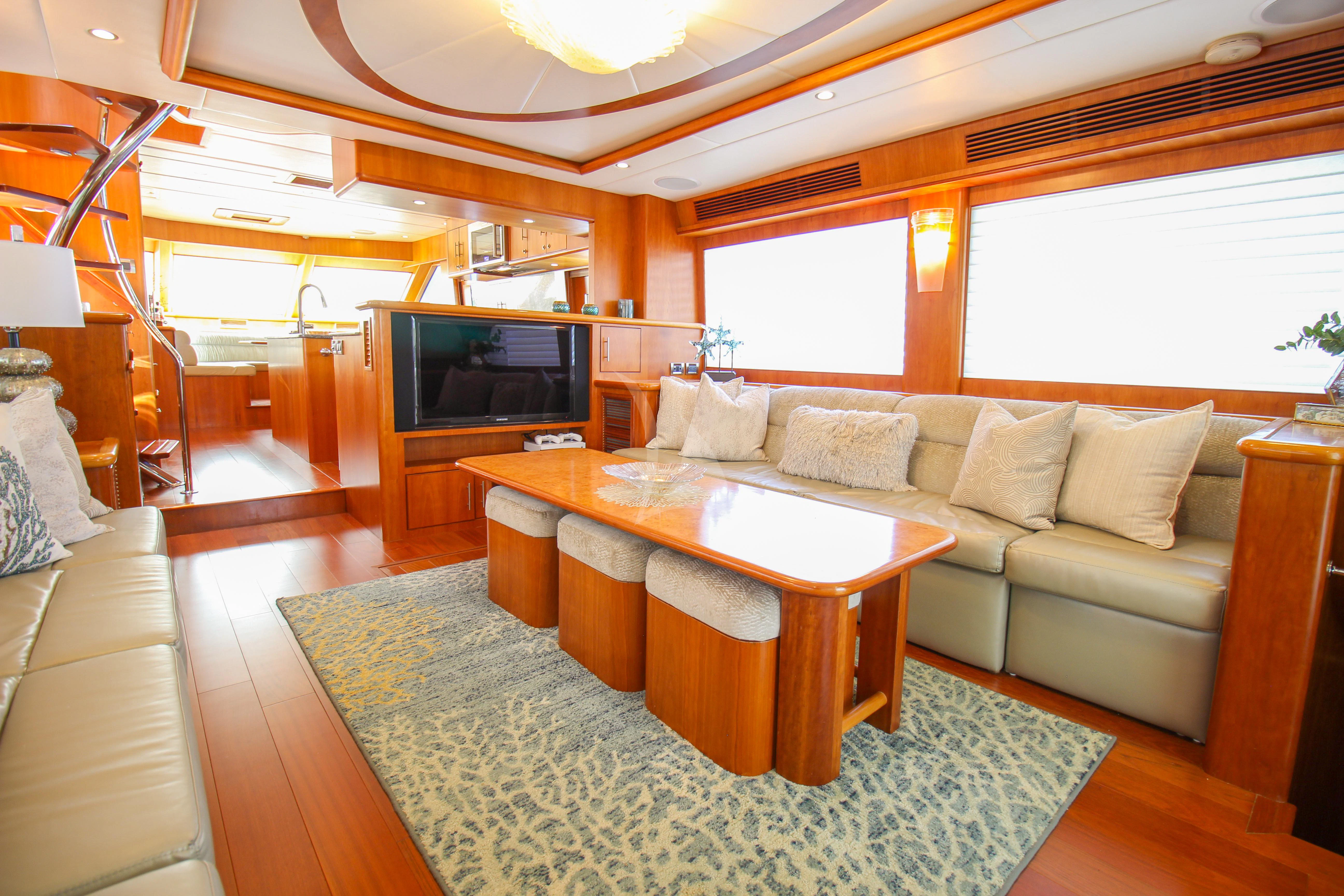 a living room with a large tv aboard ANDIAMO Yacht for Charter
