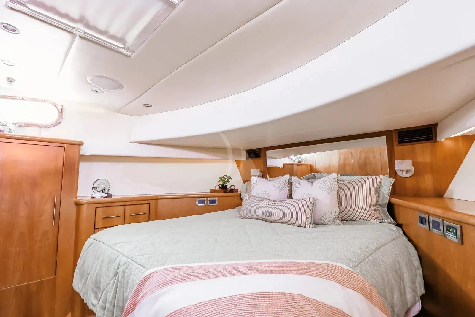 a bedroom with a bed and a dresser aboard ANDIAMO Yacht for Charter