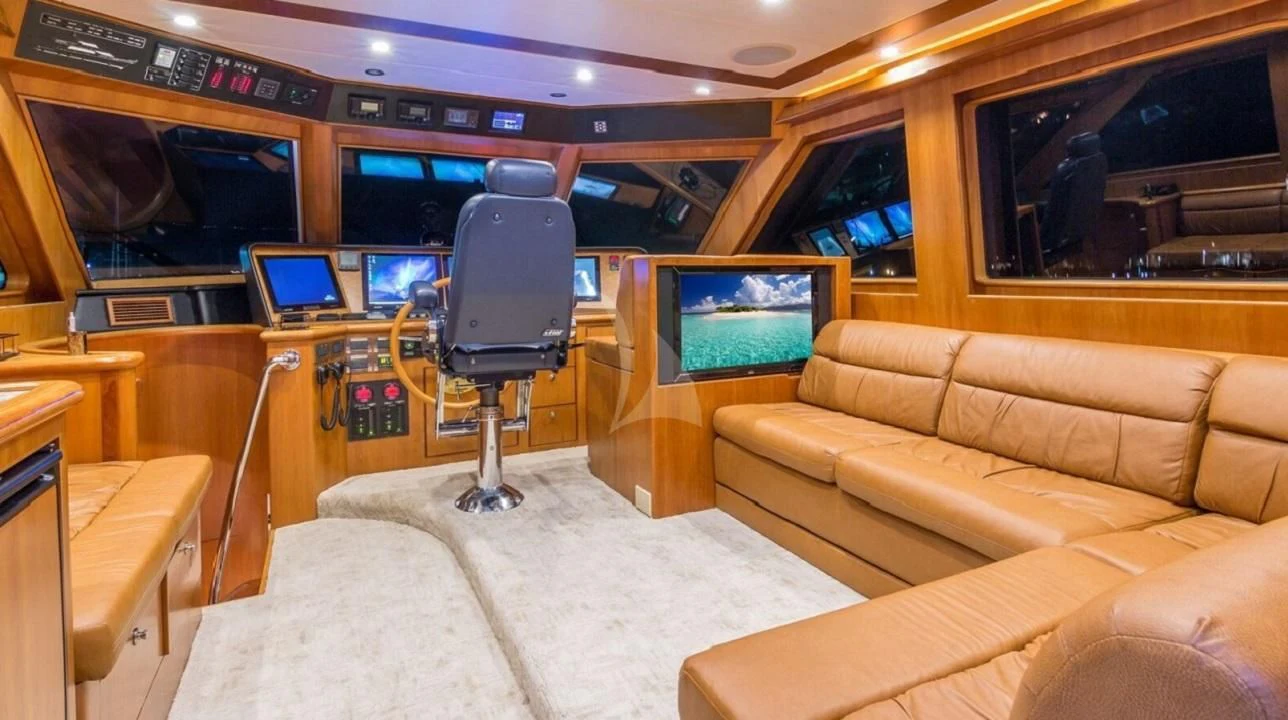 a room with a couch and a television aboard ANDIAMO Yacht for Charter