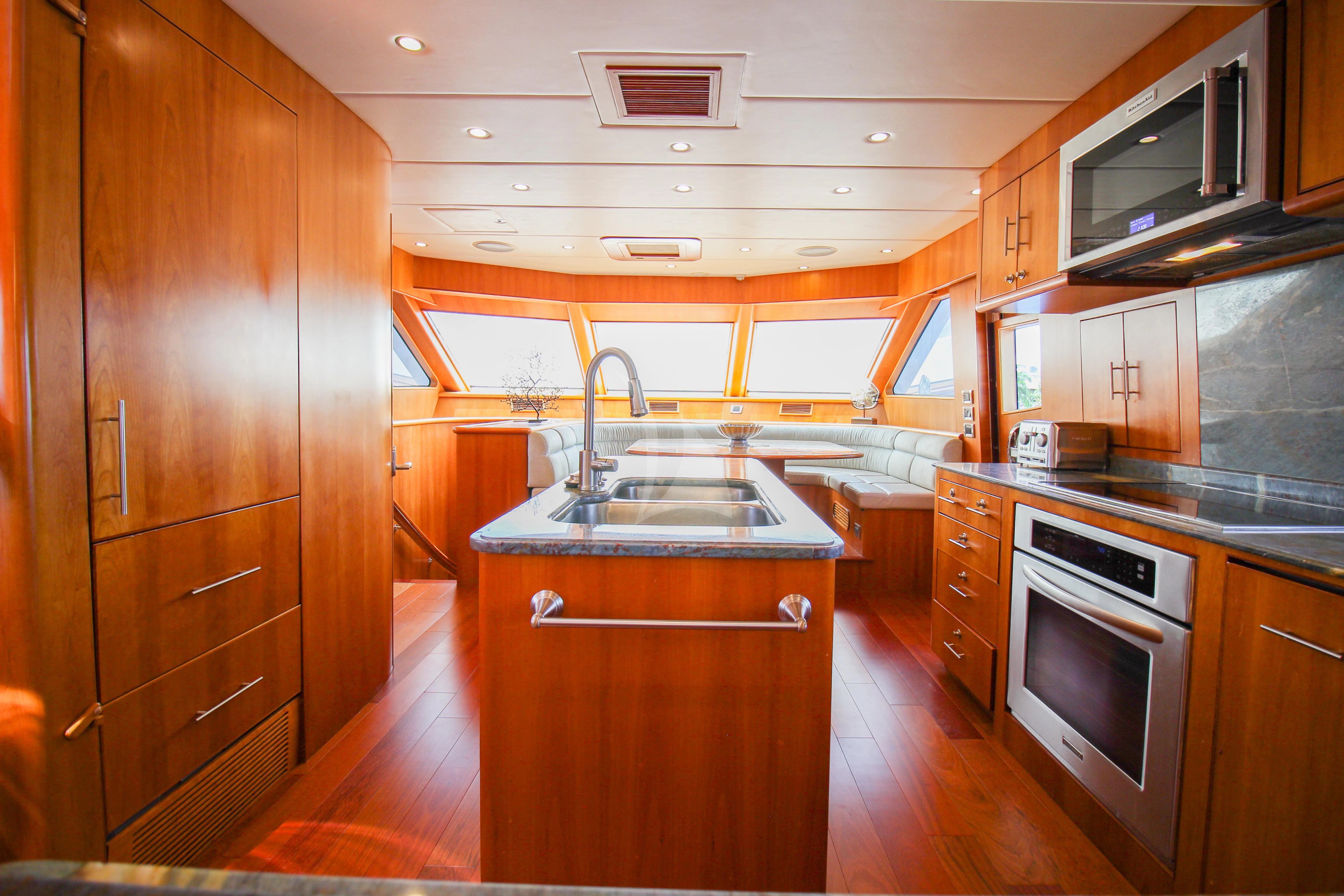 a kitchen with wooden cabinets aboard ANDIAMO Yacht for Charter