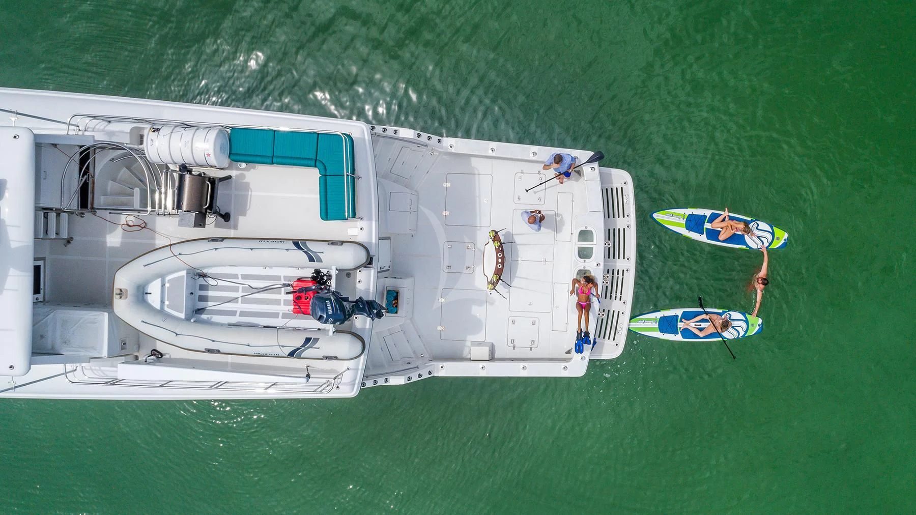 a white boat on a green lawn aboard ANDIAMO Yacht for Charter