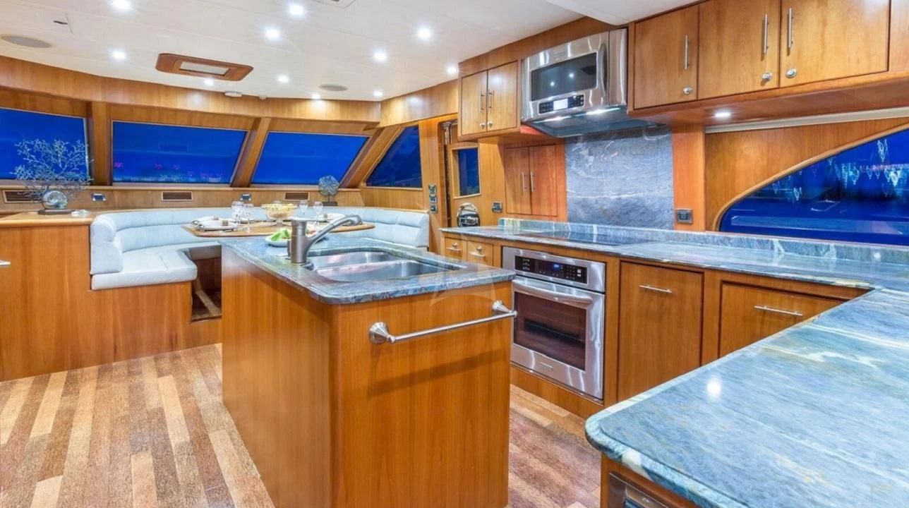 a kitchen with wooden cabinets aboard ANDIAMO Yacht for Charter