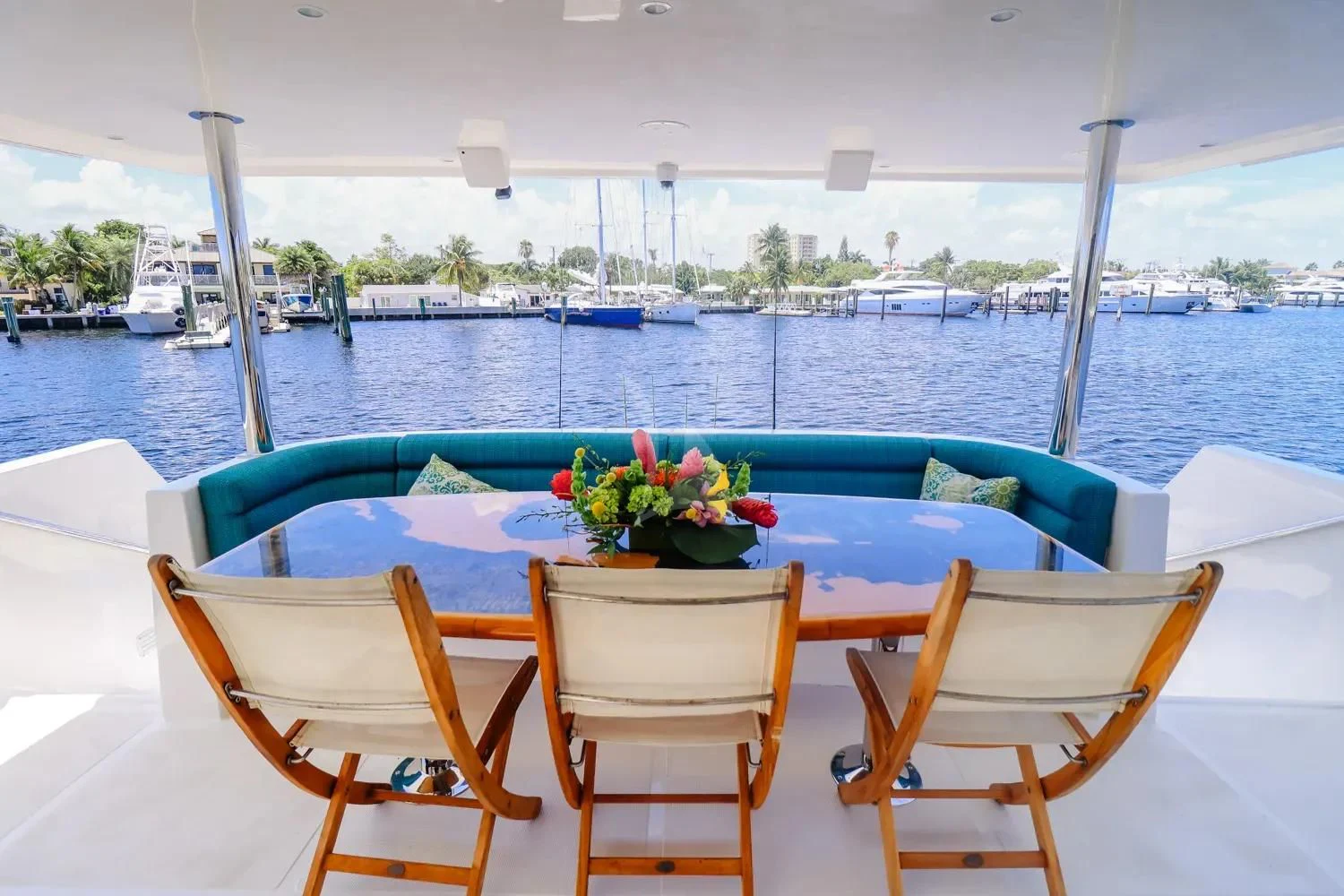a table with chairs on it next to a pool of water aboard ANDIAMO Yacht for Charter