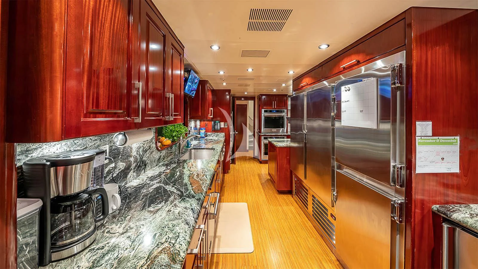 a kitchen with a stainless steel refrigerator aboard CARTE BLANCHE Yacht for Charter