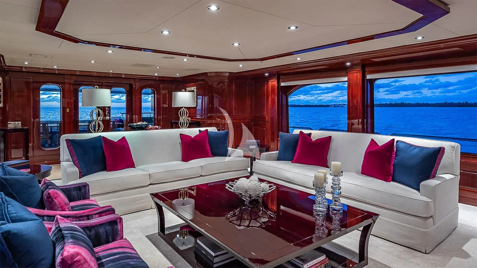 a living room with a large sofa and a coffee table aboard CARTE BLANCHE Yacht for Charter