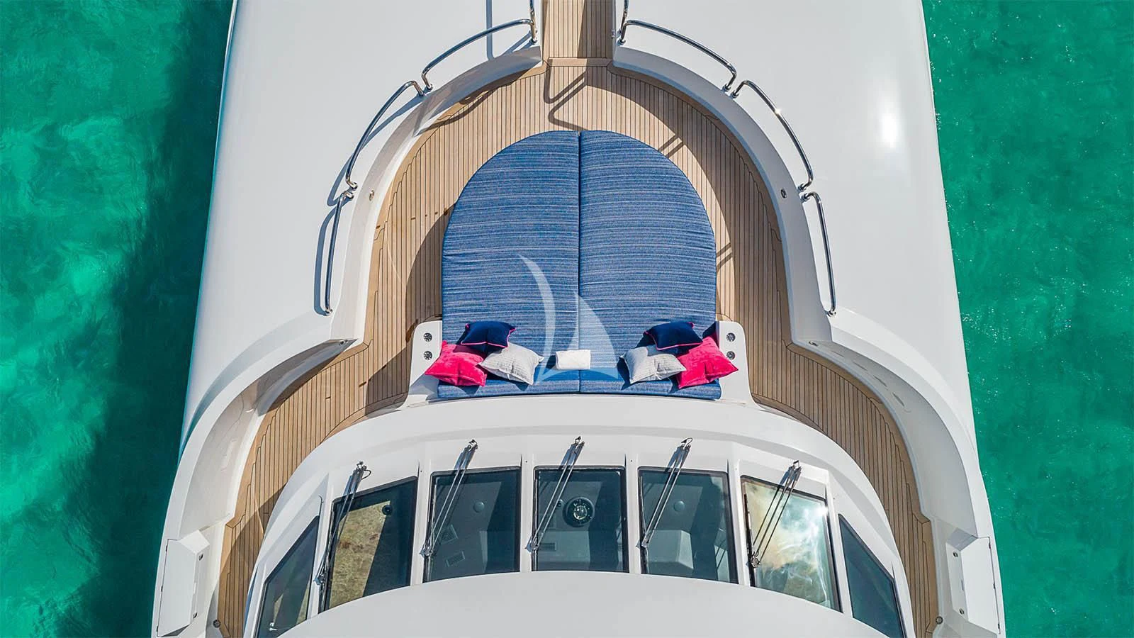 a group of people sitting on a white vehicle in a building aboard CARTE BLANCHE Yacht for Charter