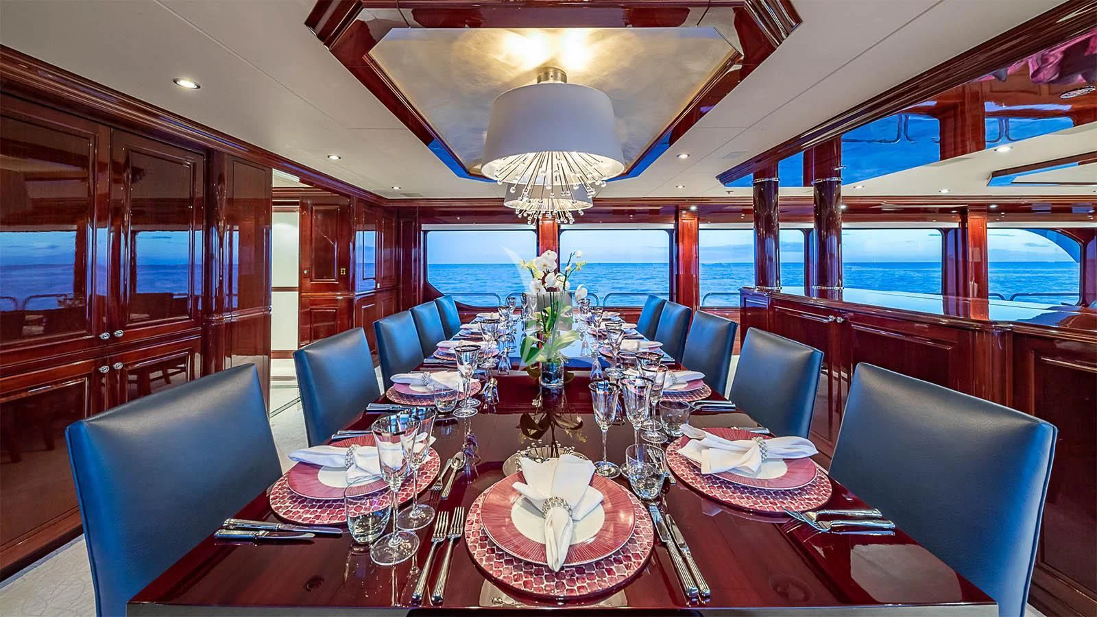 a dining room with a table set aboard CARTE BLANCHE Yacht for Charter