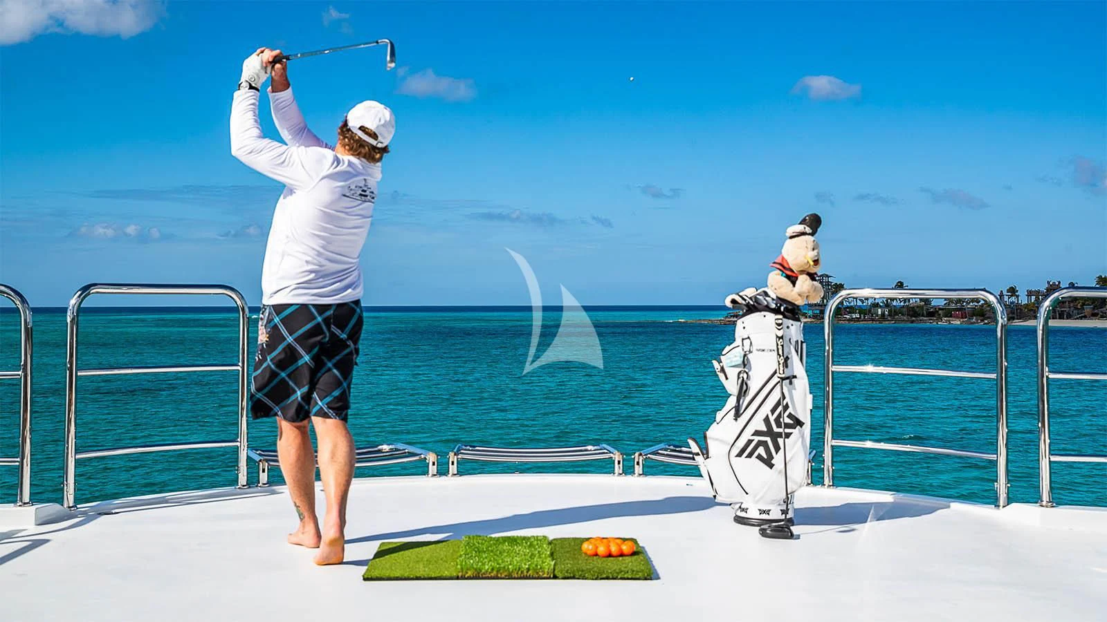 a woman hitting a fish with a fishing pole aboard CARTE BLANCHE Yacht for Charter