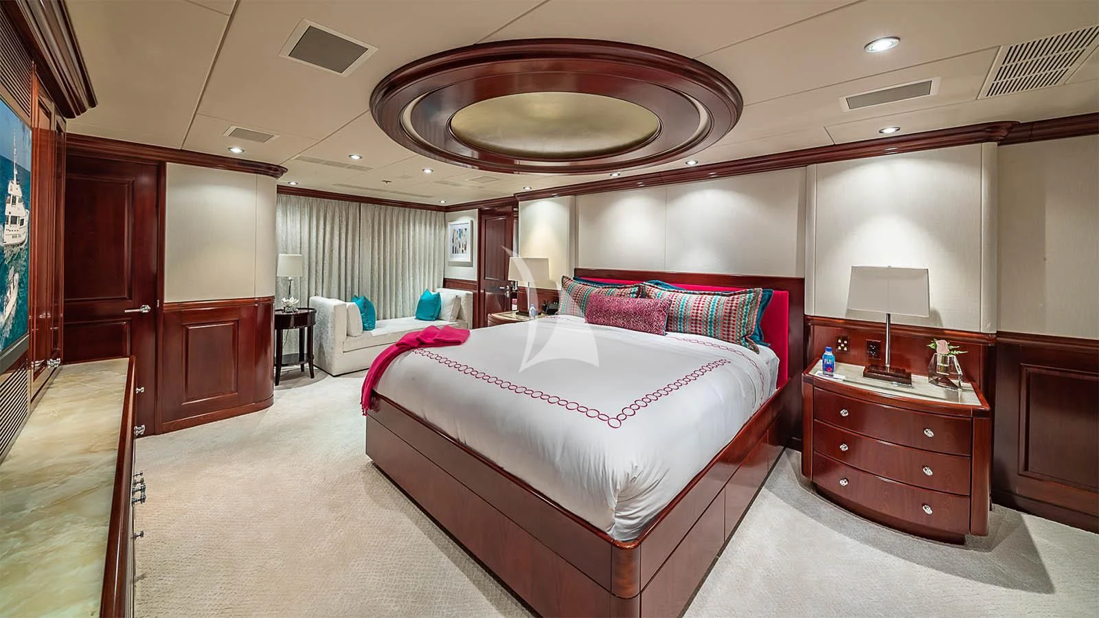 a room with a bed and a mirror aboard CARTE BLANCHE Yacht for Charter