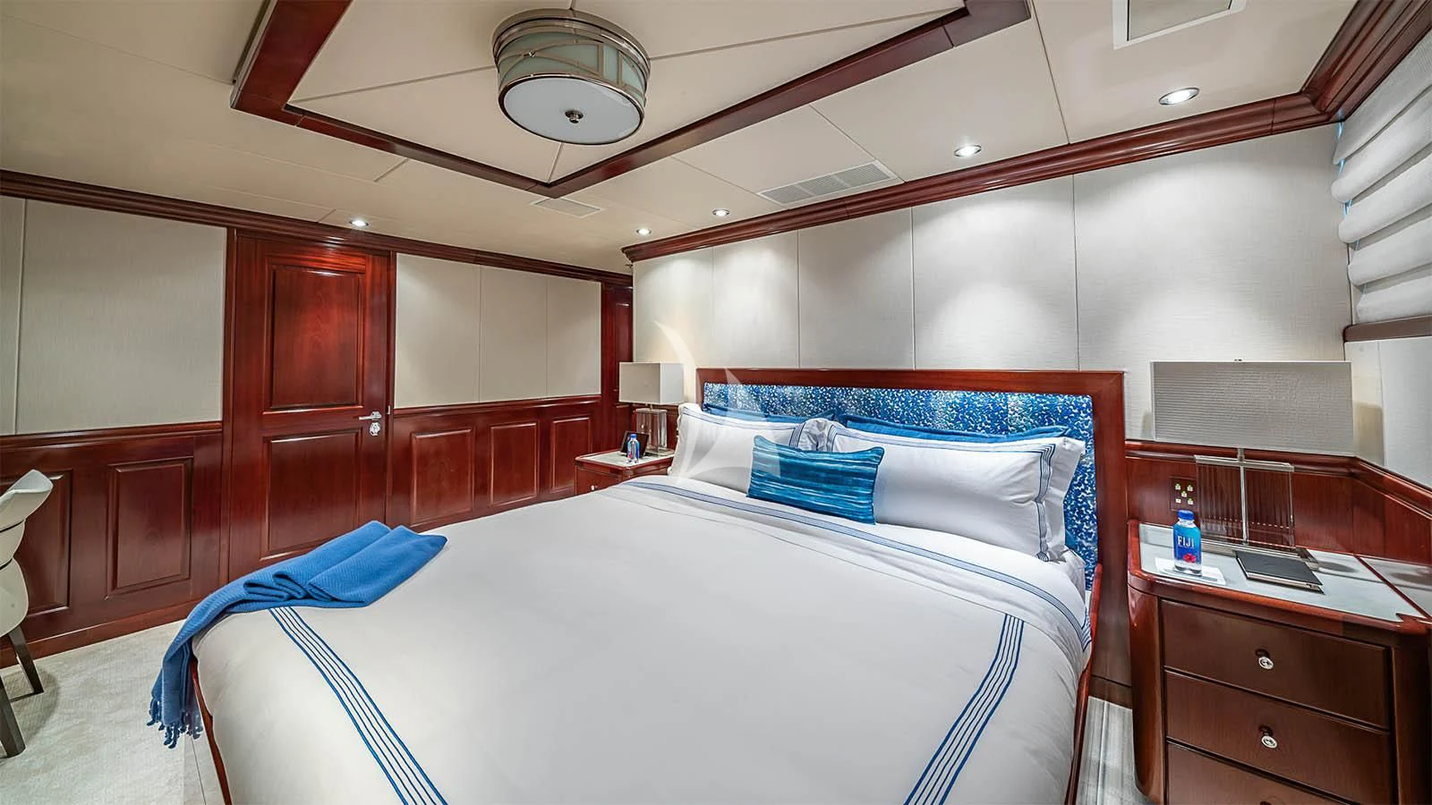 a room with a bed and desk aboard CARTE BLANCHE Yacht for Charter