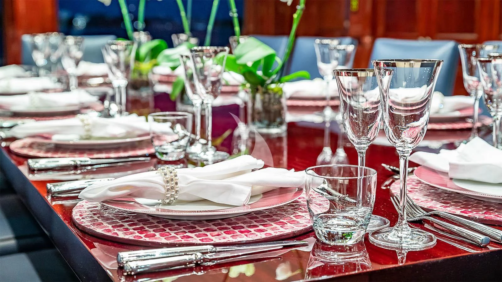 a table with plates and glasses aboard CARTE BLANCHE Yacht for Charter