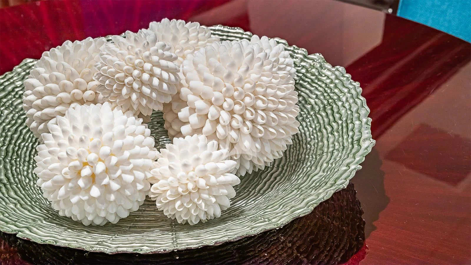 a hand holding a white flower aboard CARTE BLANCHE Yacht for Charter