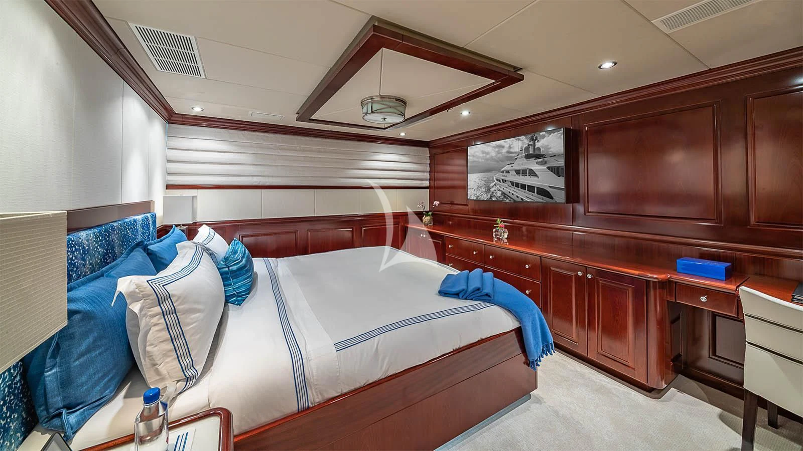 a room with a bed and a desk aboard CARTE BLANCHE Yacht for Charter