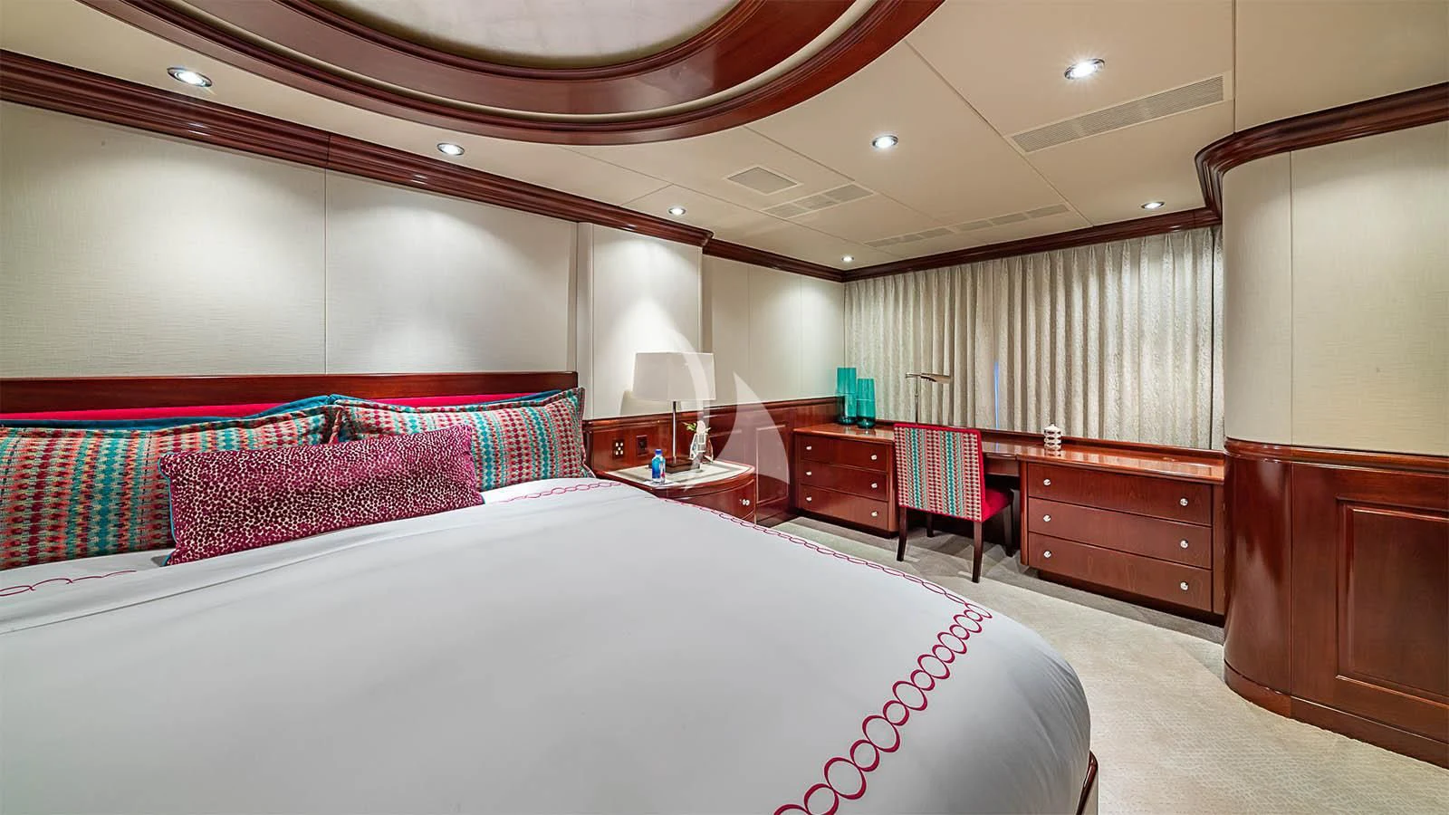 a room with a bed and a desk aboard CARTE BLANCHE Yacht for Charter