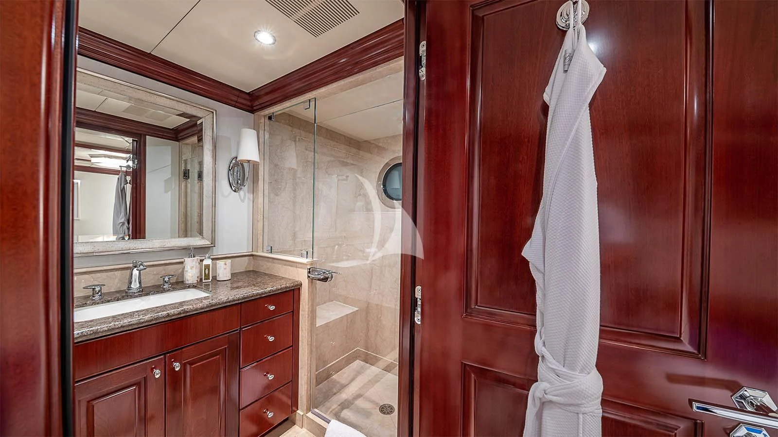 a bathroom with a robe on the wall aboard CARTE BLANCHE Yacht for Charter