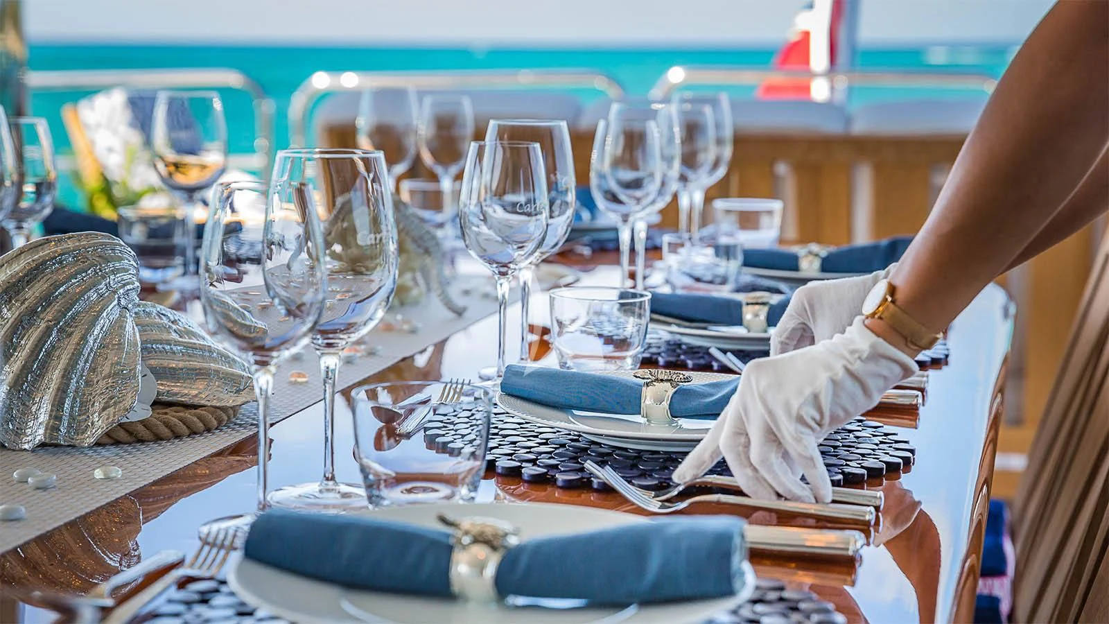a table with many wine glasses aboard CARTE BLANCHE Yacht for Charter