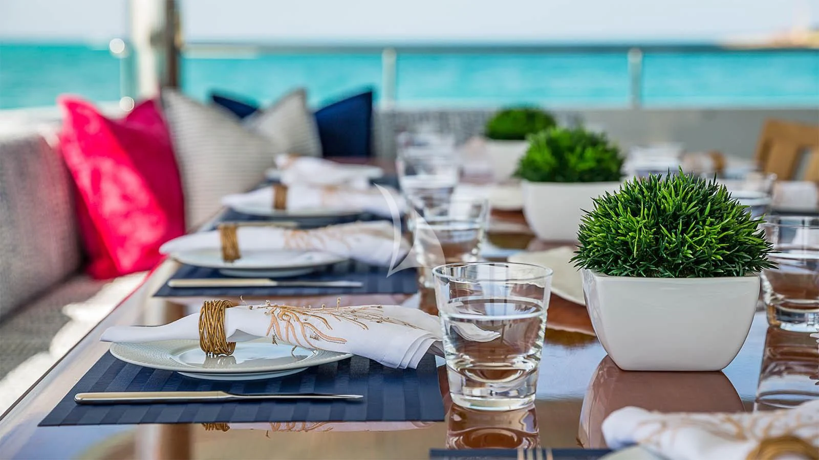 a table with plates and glasses on it aboard CARTE BLANCHE Yacht for Charter