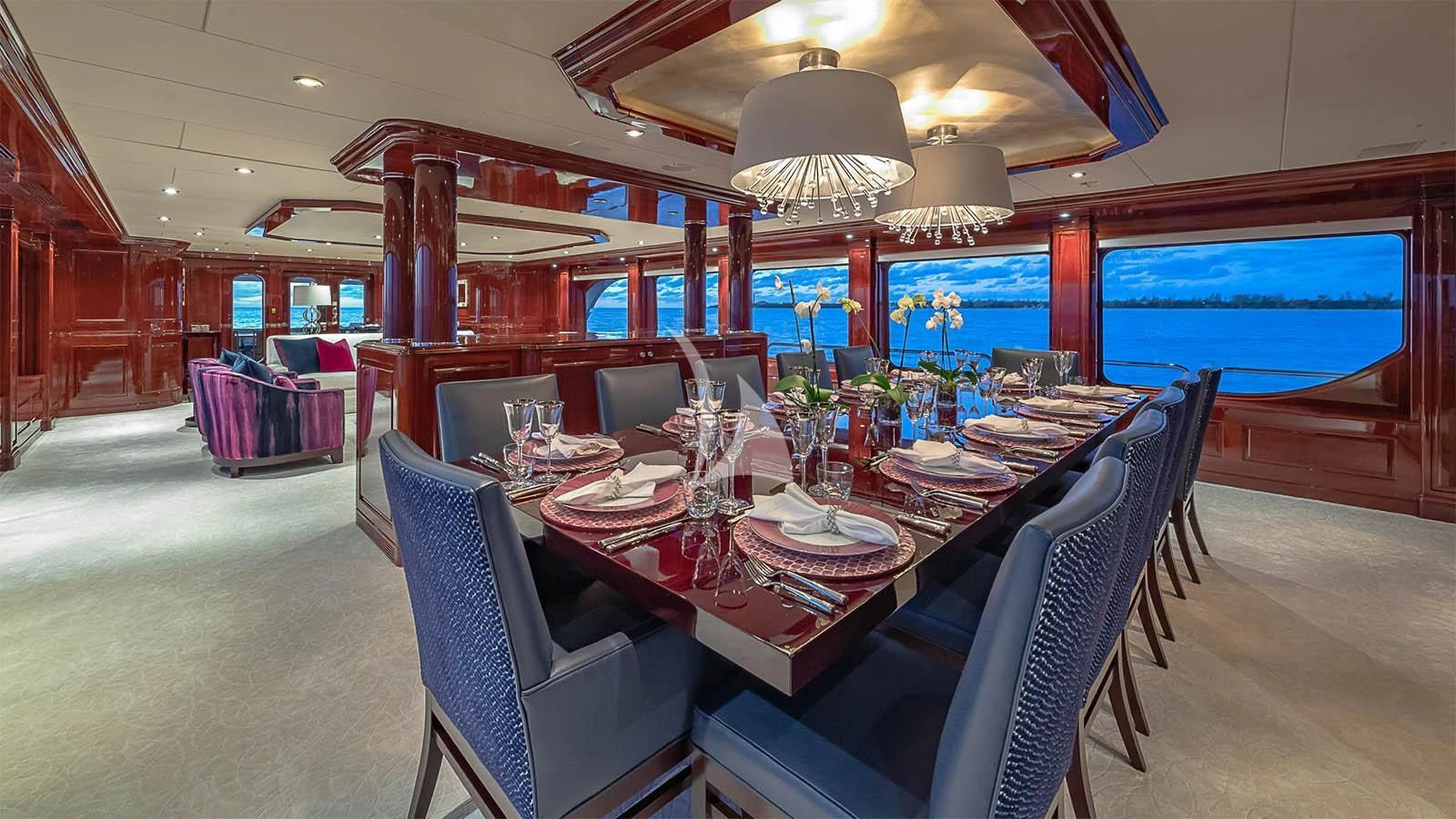 a dining room with a table set for a dinner aboard CARTE BLANCHE Yacht for Charter