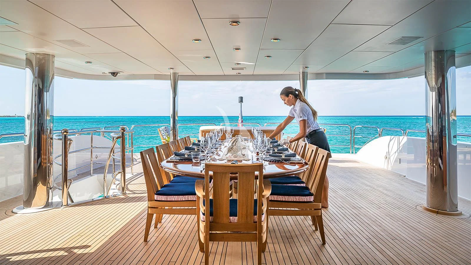 a person sitting at a table on a boat aboard CARTE BLANCHE Yacht for Charter