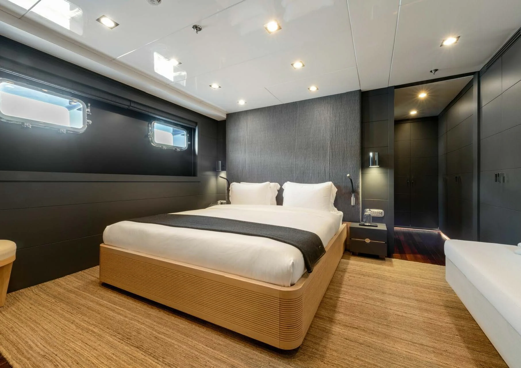 a room with a bed and a large mirror aboard ZIA Yacht for Sale