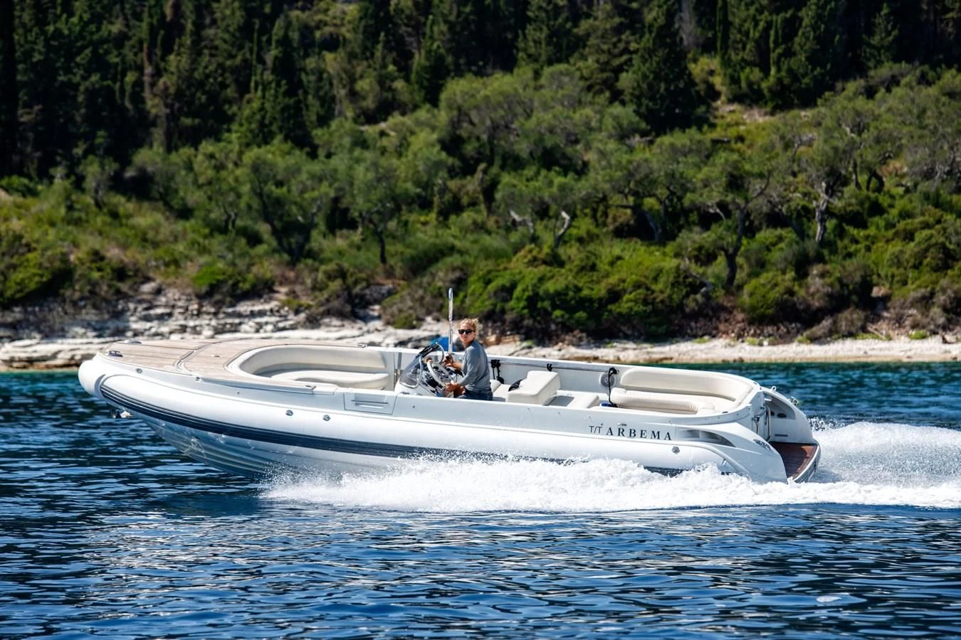 a man driving a boat aboard ZIA Yacht for Sale