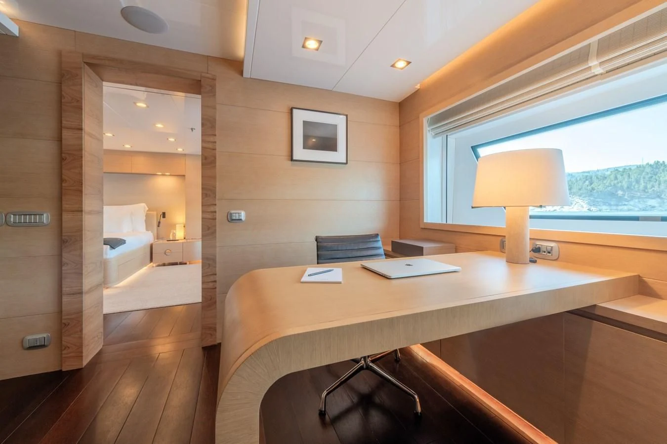 a room with a desk and a lamp aboard ZIA Yacht for Sale