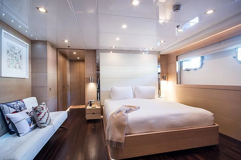 a room with a bed and a couch aboard ZIA Yacht for Sale